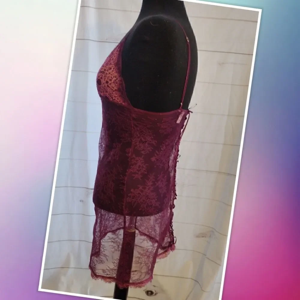 Victoria Secret XS maroon lace top. Features lace tie on the back, gold accent